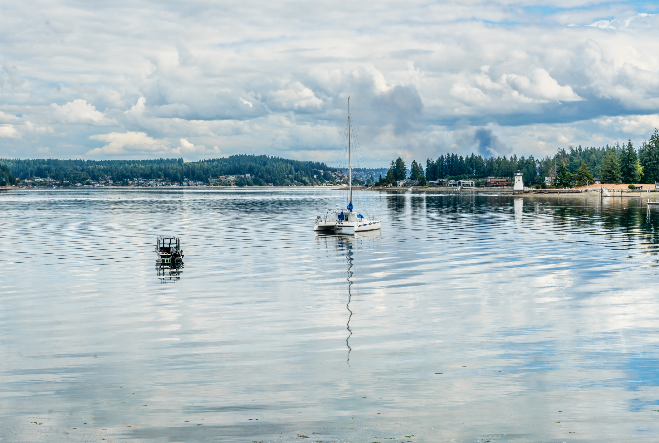 A view of a boat and lighthouse at Fox Island near Gig Harbor, washington.